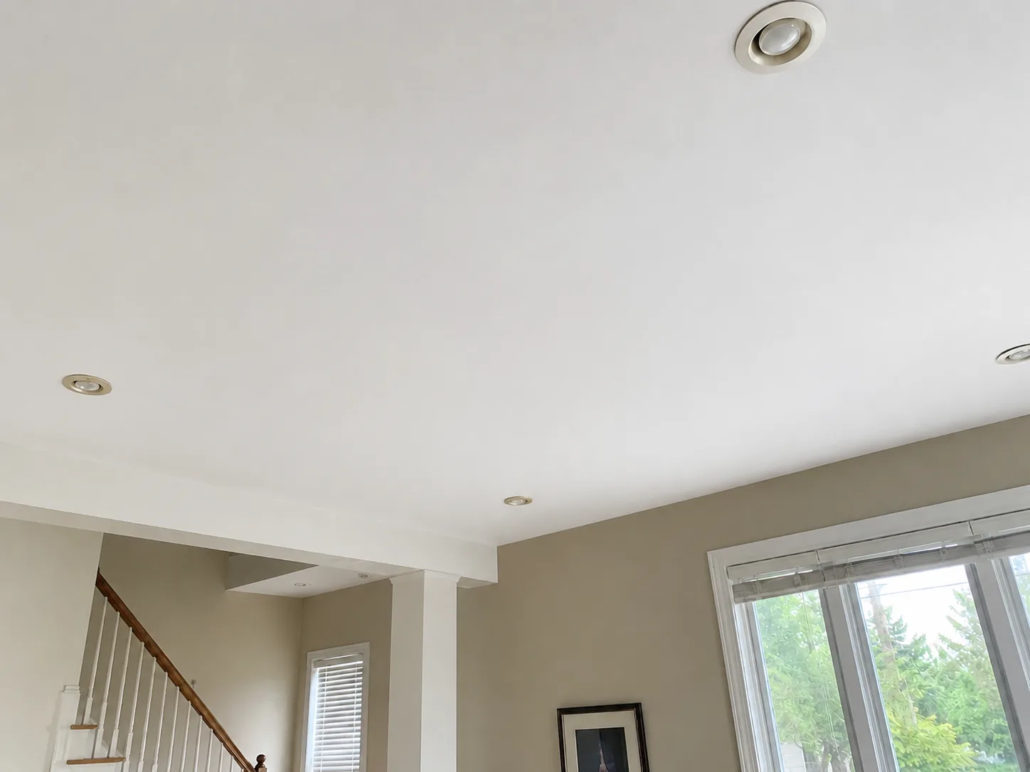 Ceiling after hole repair, drywall finishing, and smooth white repainting
