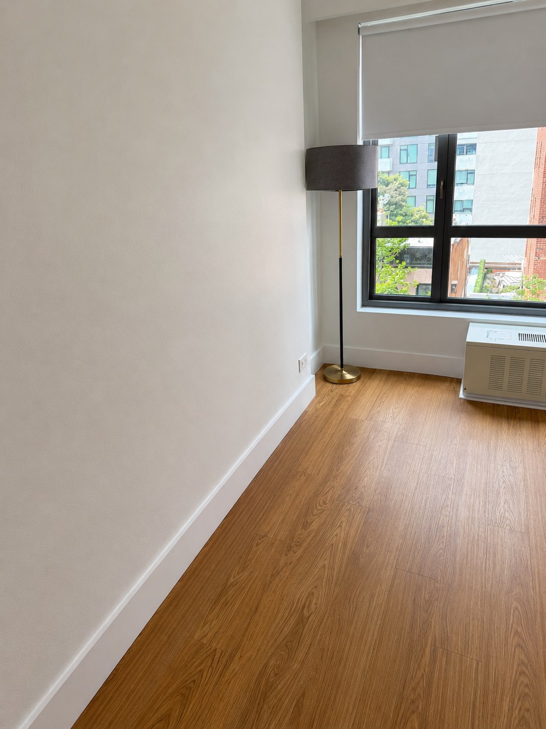 Fresh apartment wall and flooring finish near window — interior painting in NYC by Residential Finishes