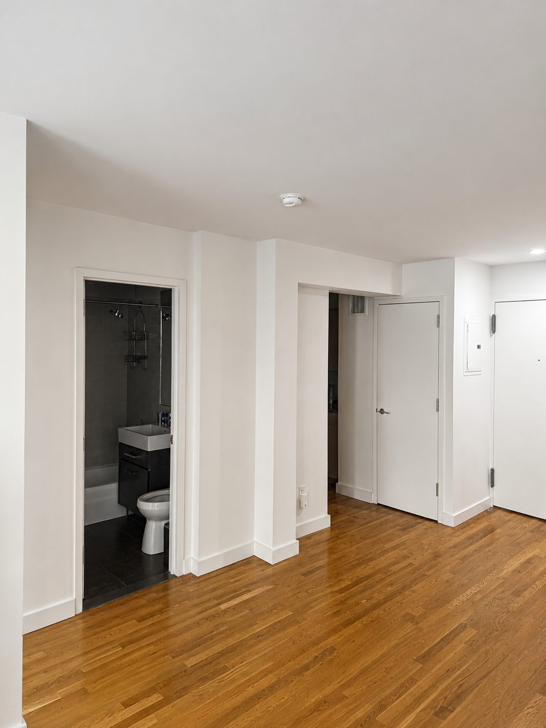 Hallway renovation with crisp white walls and hardwood flooring in New York